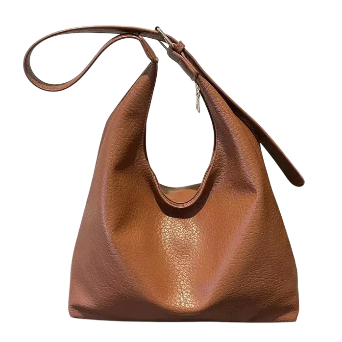 Elegant brun handväska i mjukt konstläder, tidlös design med rymlig insida som gör den perfekt för både vardag och arbete.